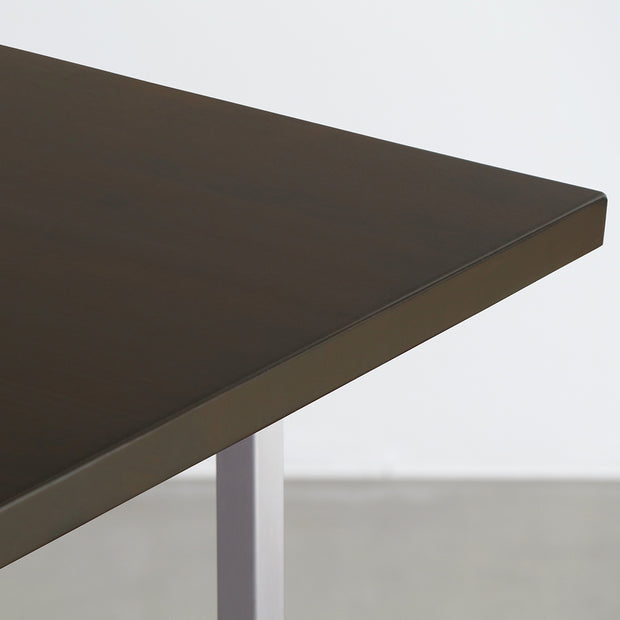 Gemoneのシックなブラックブラウンのラバーウッド材と美しい質感が際立つT型ステンレス脚を組み合わせた重厚感のあるテーブル（天板）