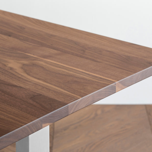 Gemoneのウォルナット天板とIライン型ステンレス脚を組み合わせた重厚感のあるテーブルの角