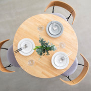Kanademonoのラバーウッドナチュラル天板とトライアングルホワイト脚4本を組み合わせたラウンド型のカフェテーブル（使用例4）