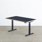 ファニチャーリノリウム素材のSmokeyBlue天板と、ブラックの電動昇降脚を組み合わせた、デザイン性も機能性もスマートなテーブル