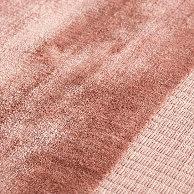 ローズピンクのリッチな光沢が美しいシンプルなラグの表面